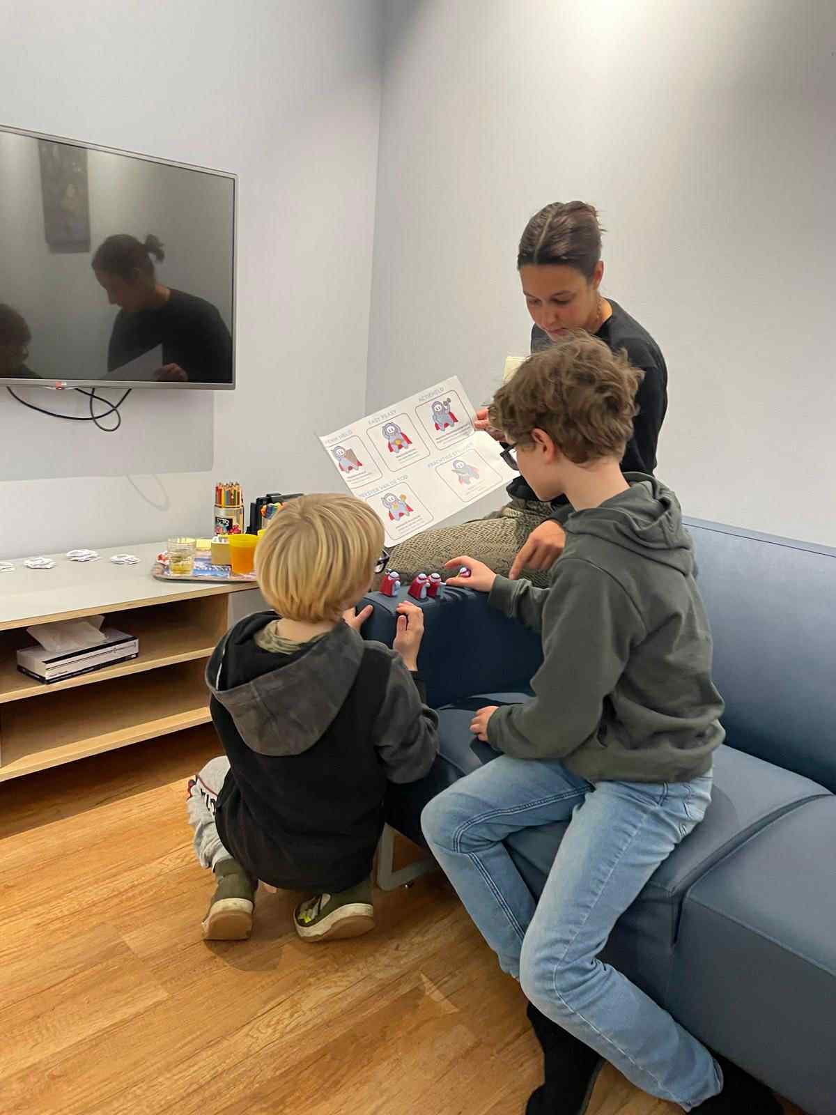 Children exploring the P-Hero figures and character sheet during a focus group