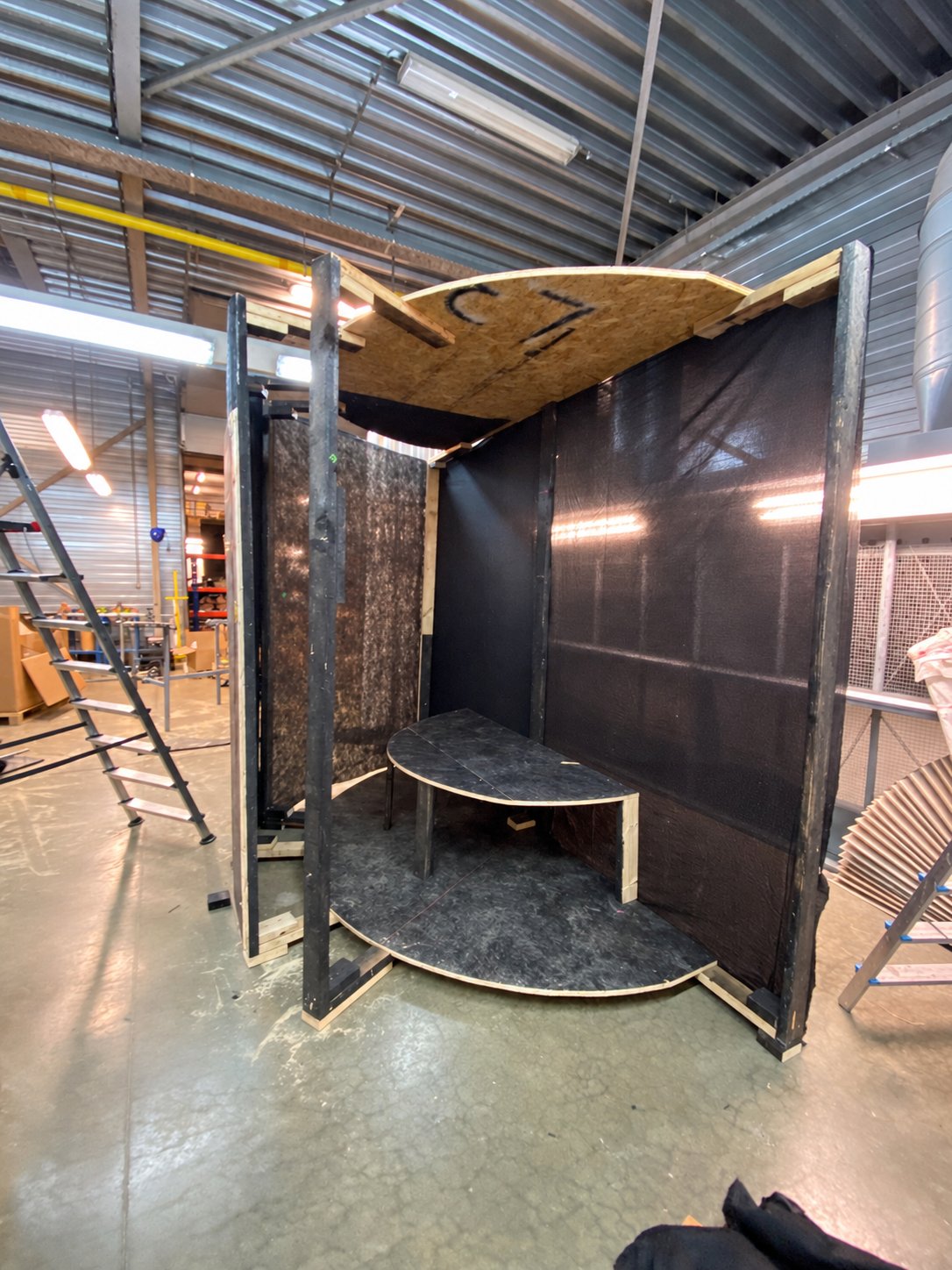 Open wooden frame of the prototype with curved floor and seating platform