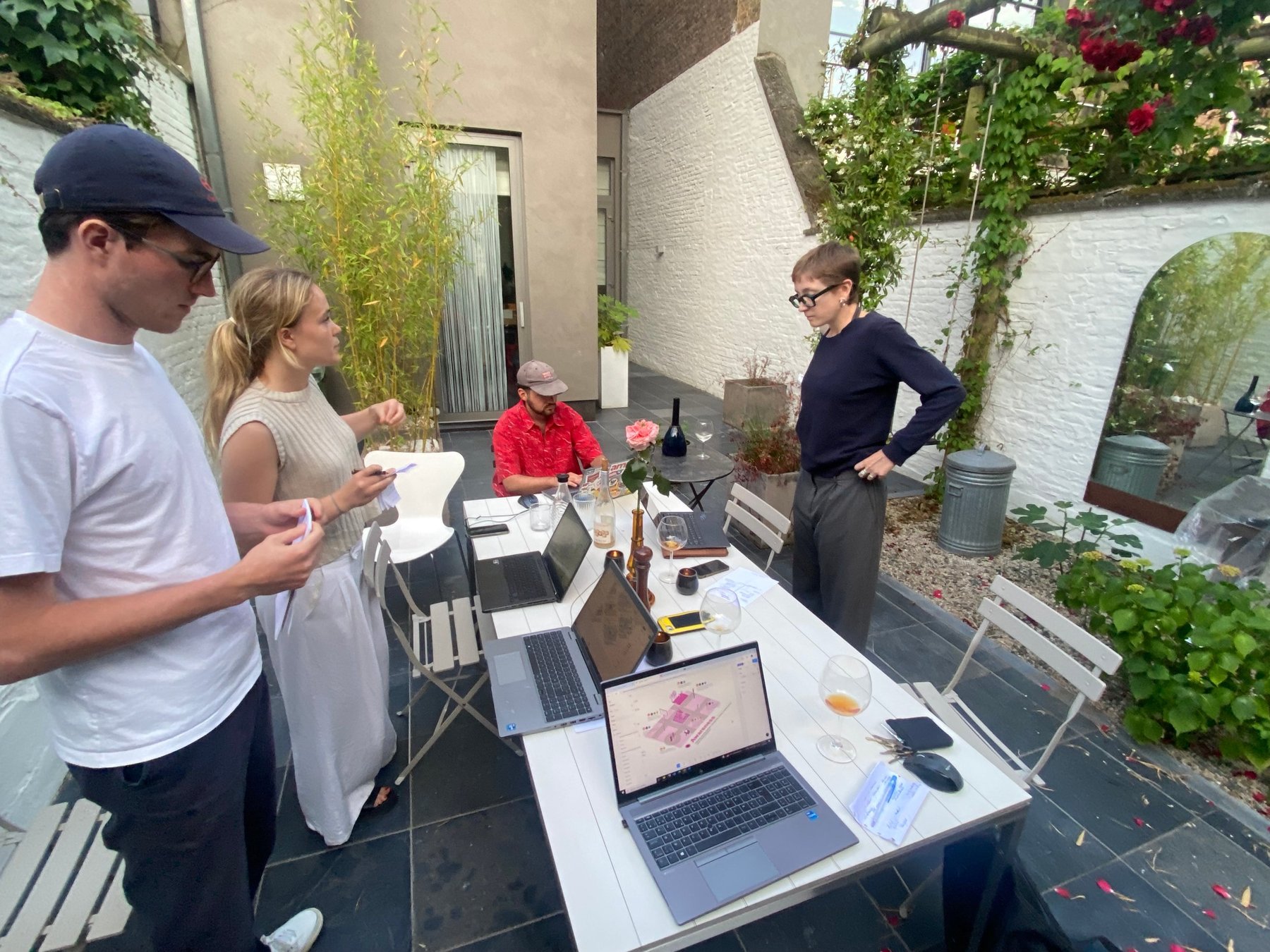 The team working on the city map illustrations around a garden table