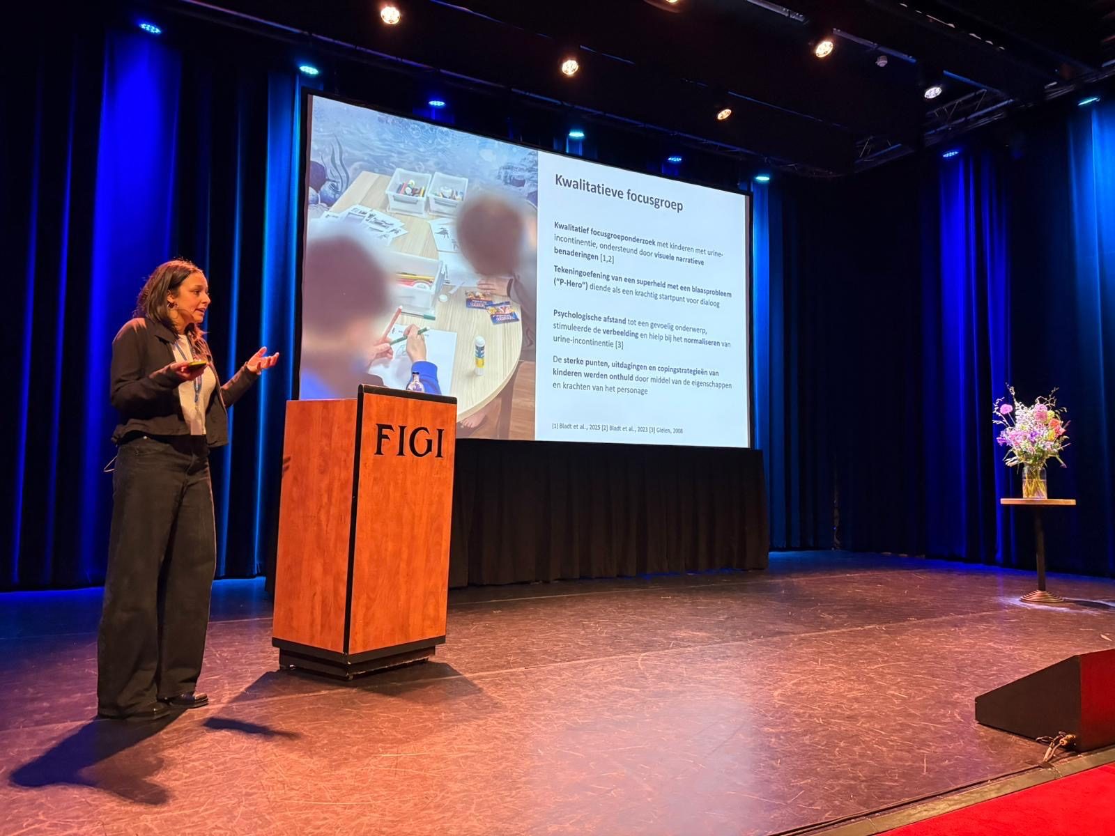 Dounia presenting the P-Heroes focus group research on stage at FIGI