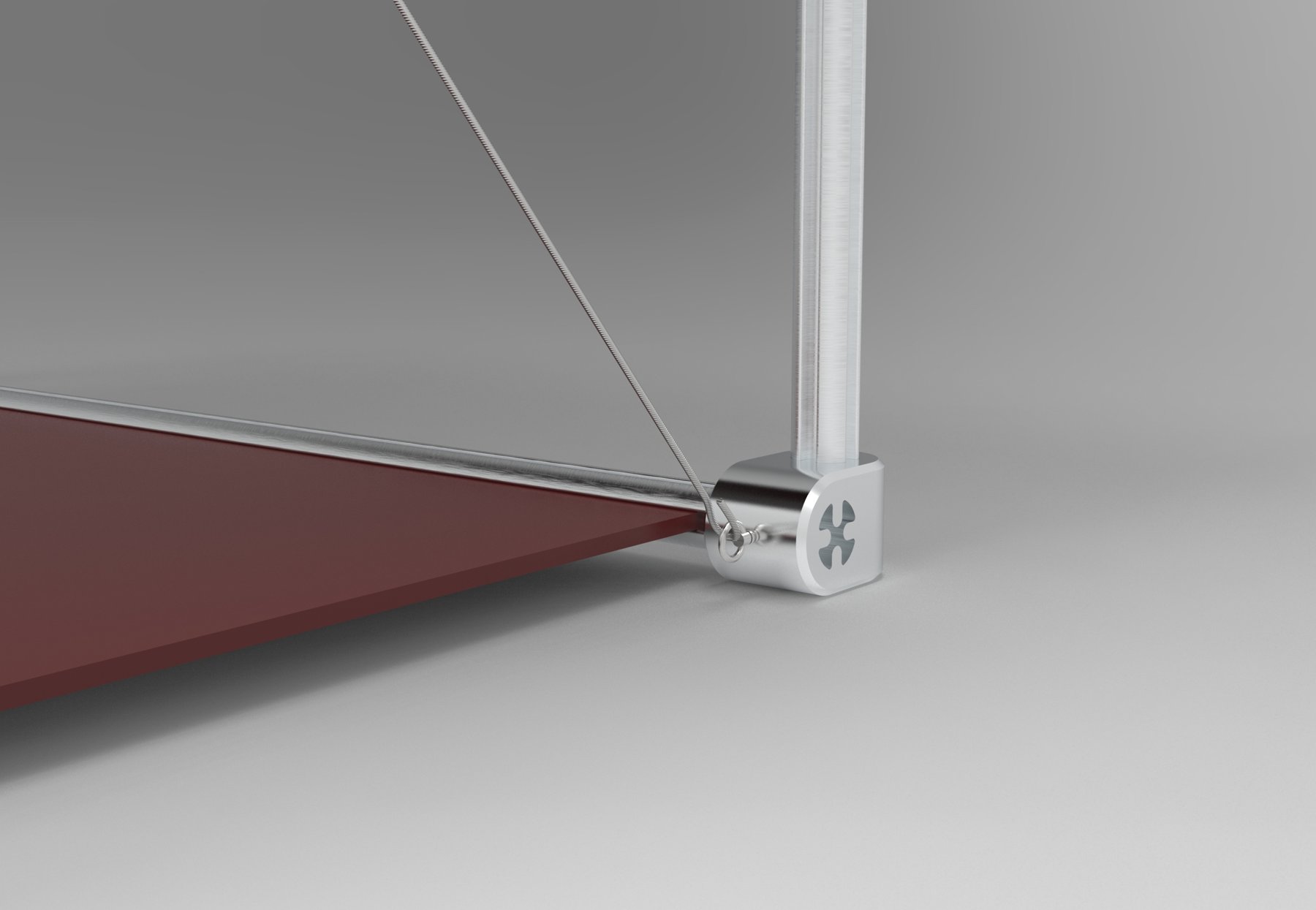 Close-up of a corner connector at the base with a cable and red shelf
