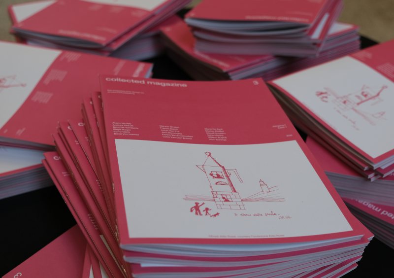 Stacks of pink magazines on a table